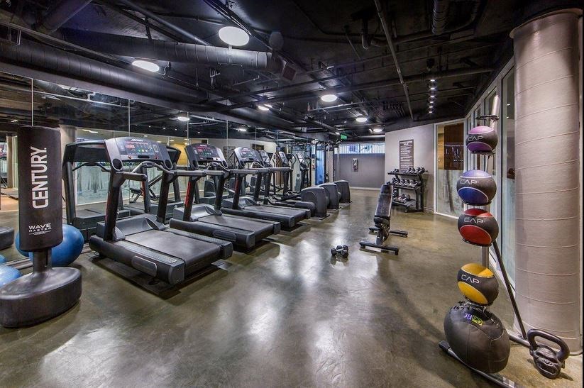 a row of exercise equipment in a gym