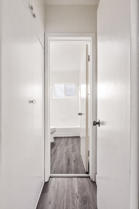 A white door is open to a bathroom.