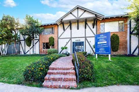 a building with a blue sign in front of it