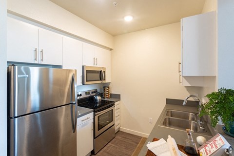 a kitchen with stainless steel appliances and a stainless steel refrigerator