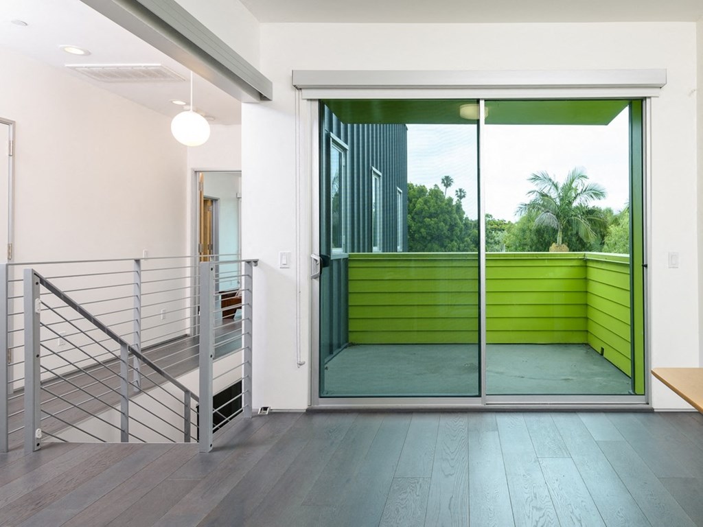a large glass door leading to a balcony in a house