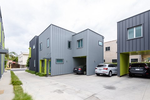 a large building with two cars parked in front of it