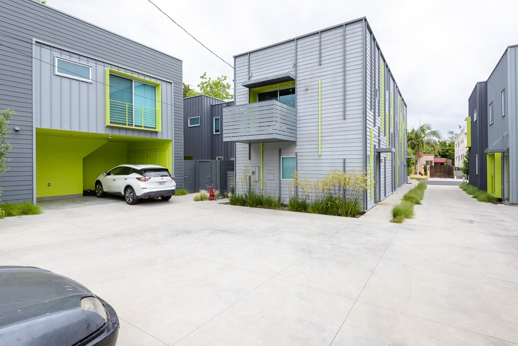 a row of houses with a car parked between them