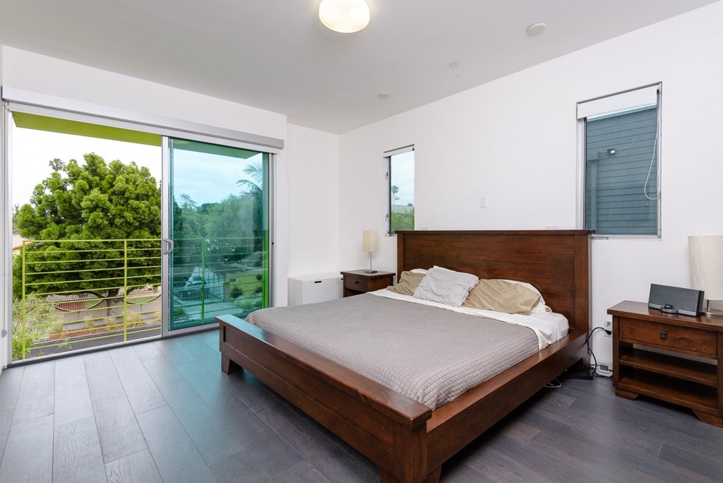 a bedroom with a bed and a sliding glass door
