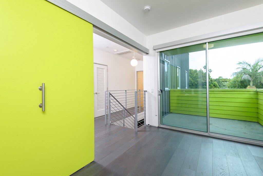 a yellow door in a room with a sliding glass door
