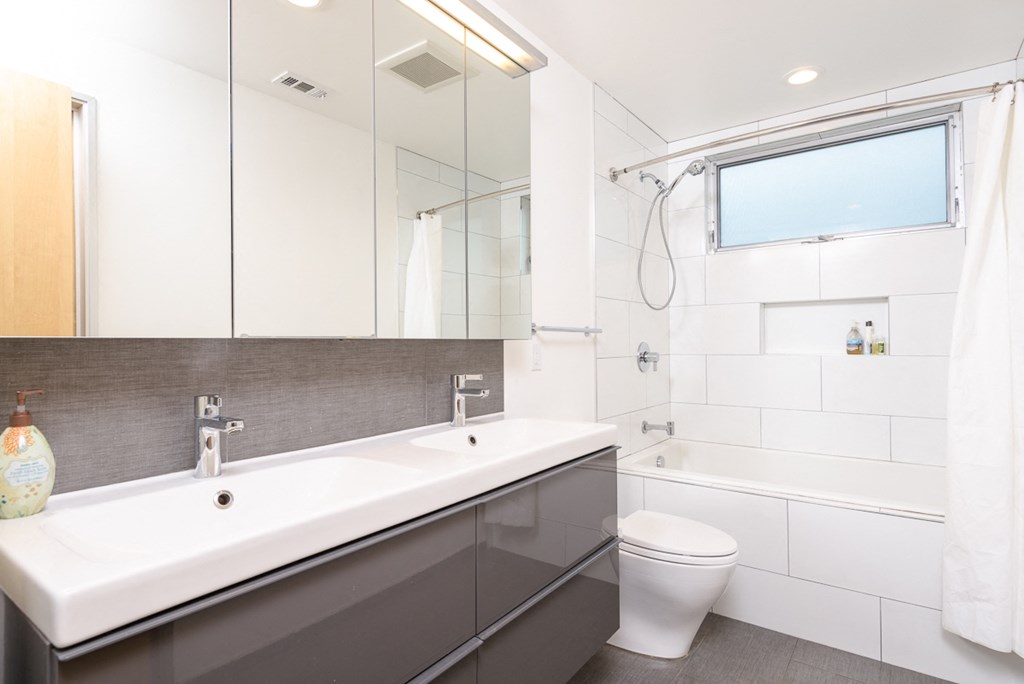 a bathroom with a sink and a toilet and a shower