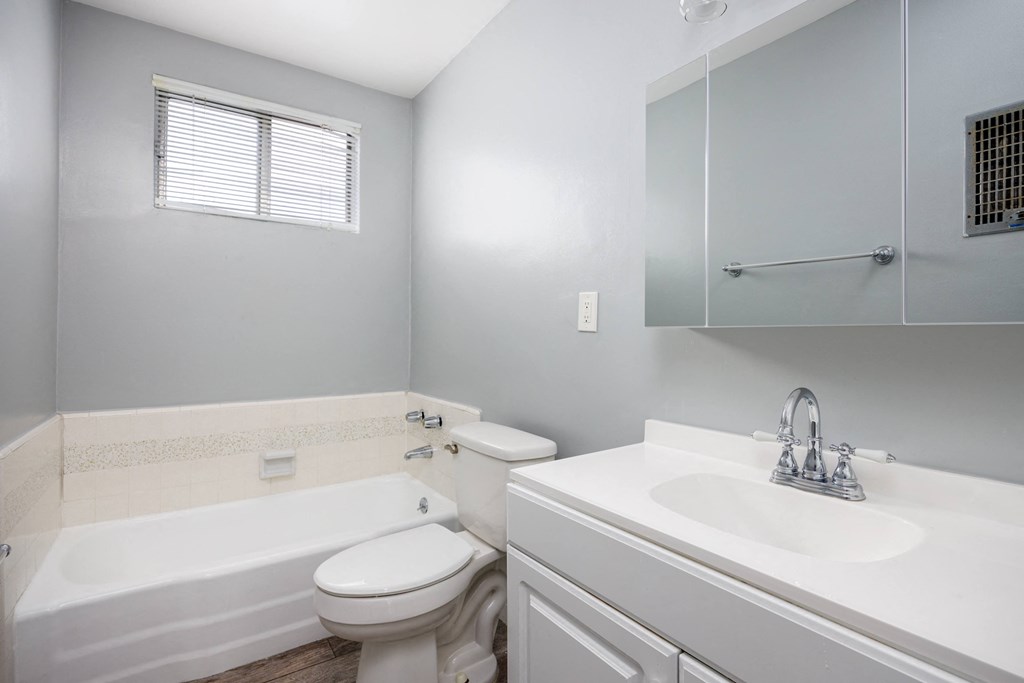 a bathroom with a sink toilet and a bath tub