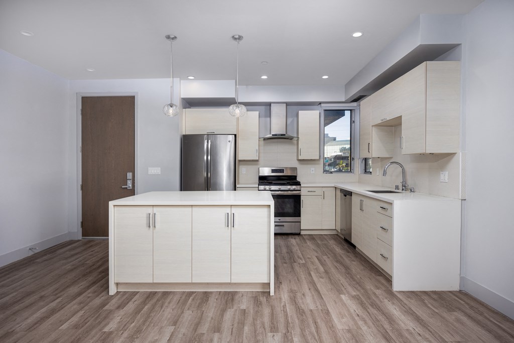a kitchen with white cabinets and stainless steel appliances