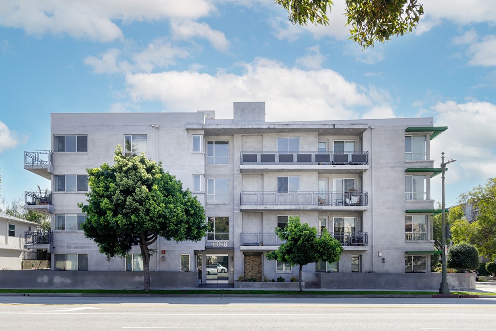 a white apartment building on the side of a street