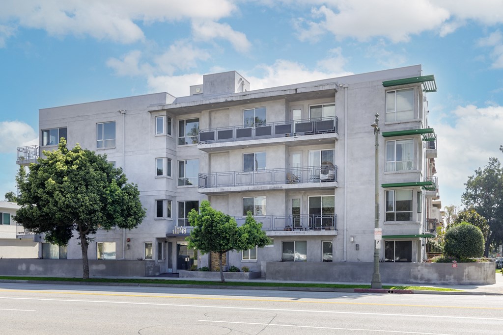 a white apartment building on the corner of a street