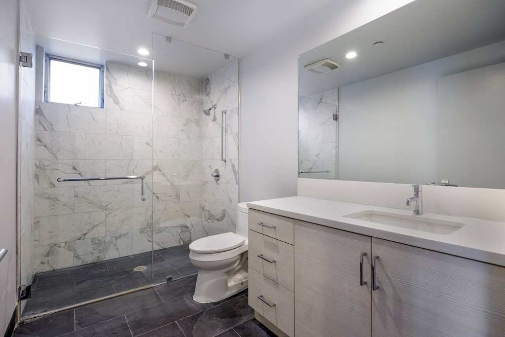 a bathroom with a toilet sink and shower