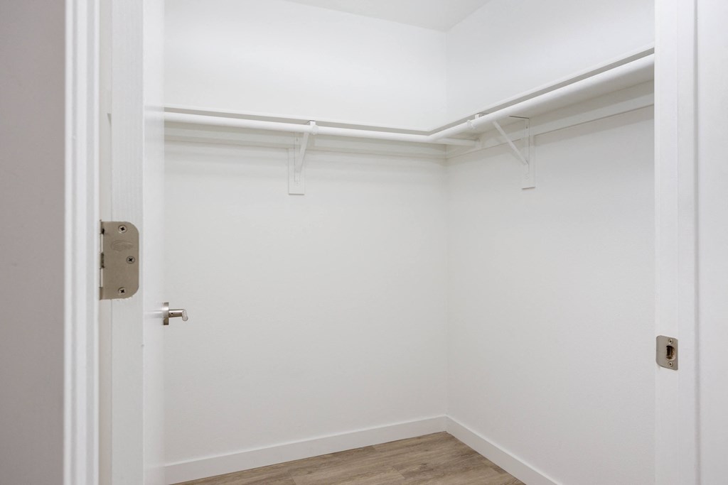 an empty room with white walls and a white door