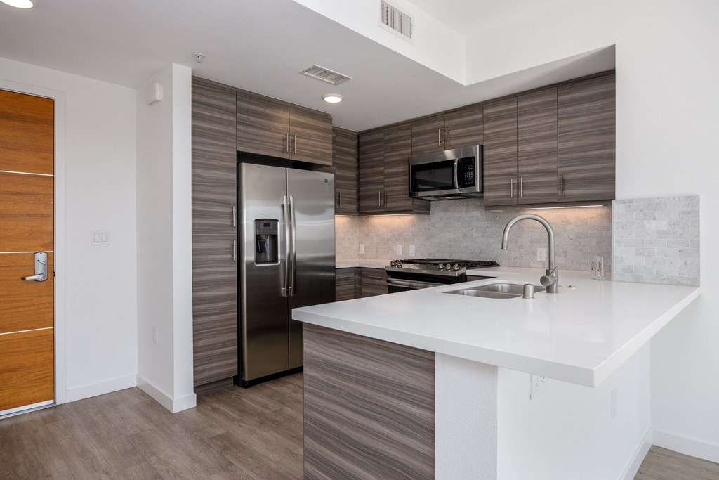 a kitchen with stainless steel appliances and a white counter top
