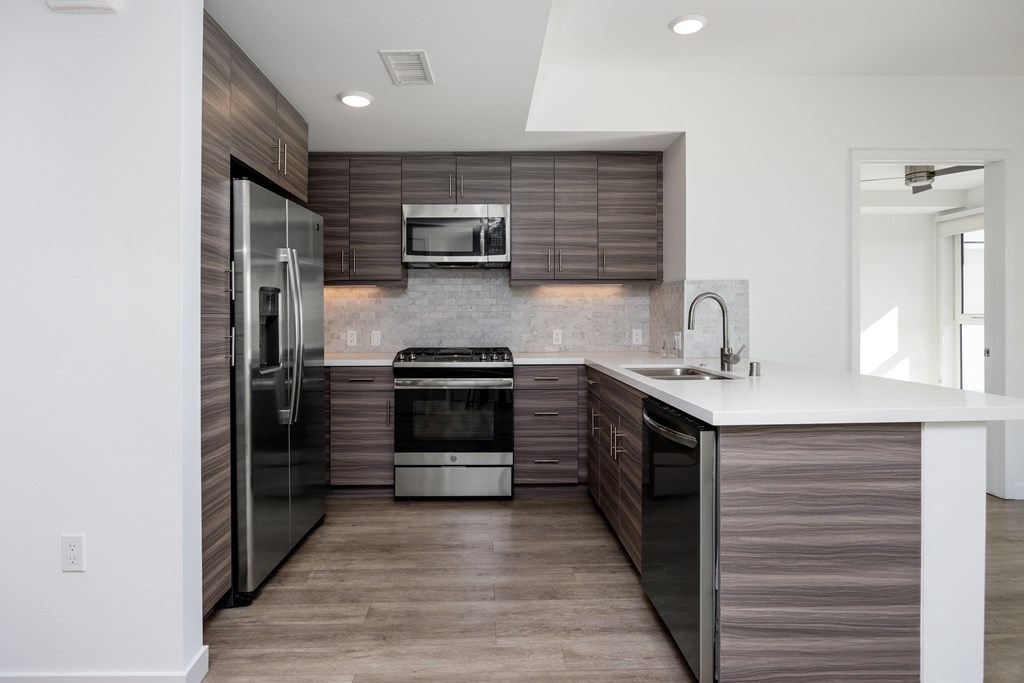 a kitchen with stainless steel appliances and a white counter top