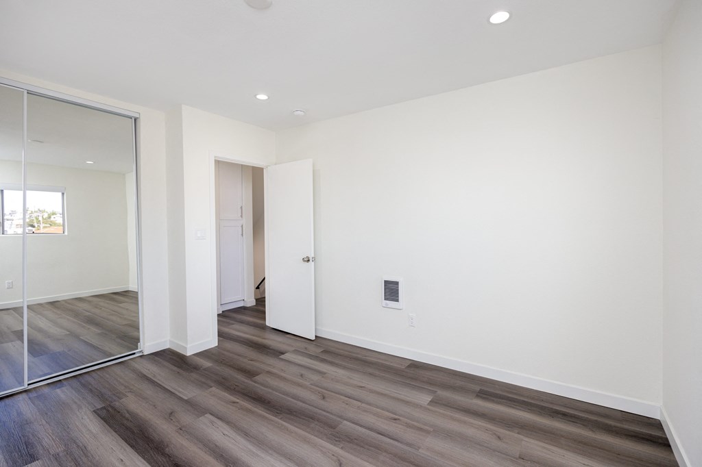 a living room with white walls and a sliding glass door