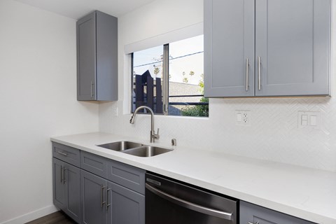 an empty kitchen with a sink and a window