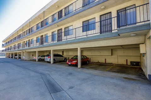 a parking garage with cars parked in front of a building