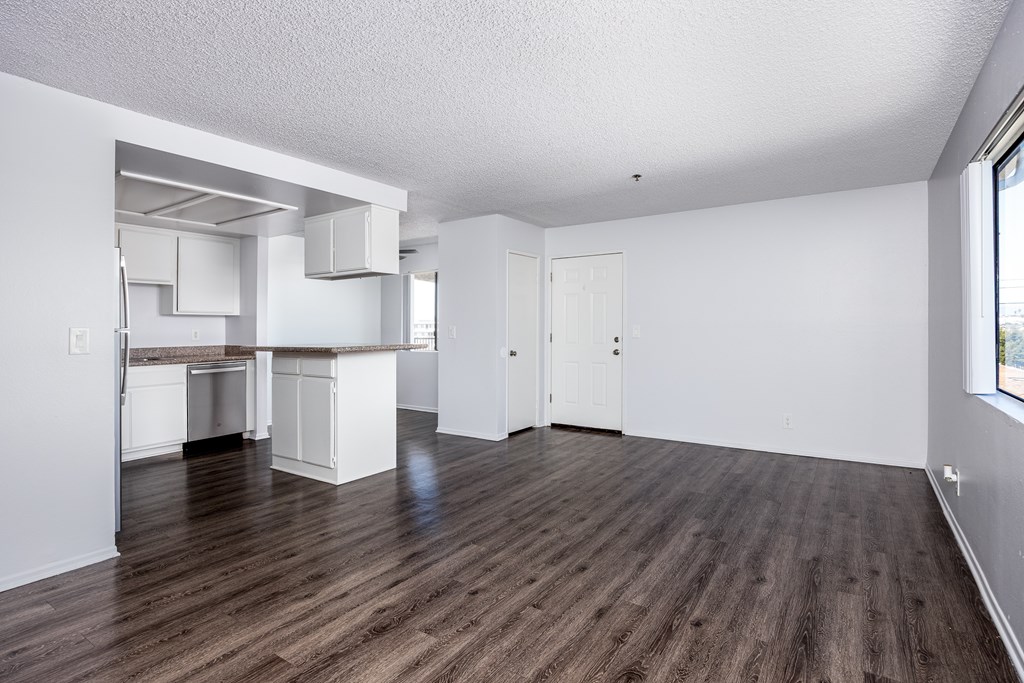 A room with wooden floors and white walls.
