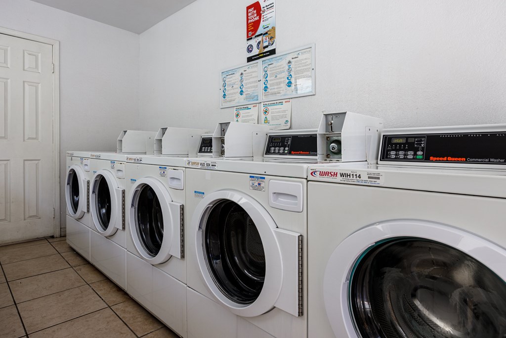 A row of washing machines in a laundromat.
