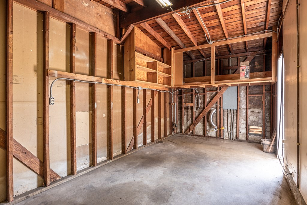 the inside of a house under construction with wood studs and walls
