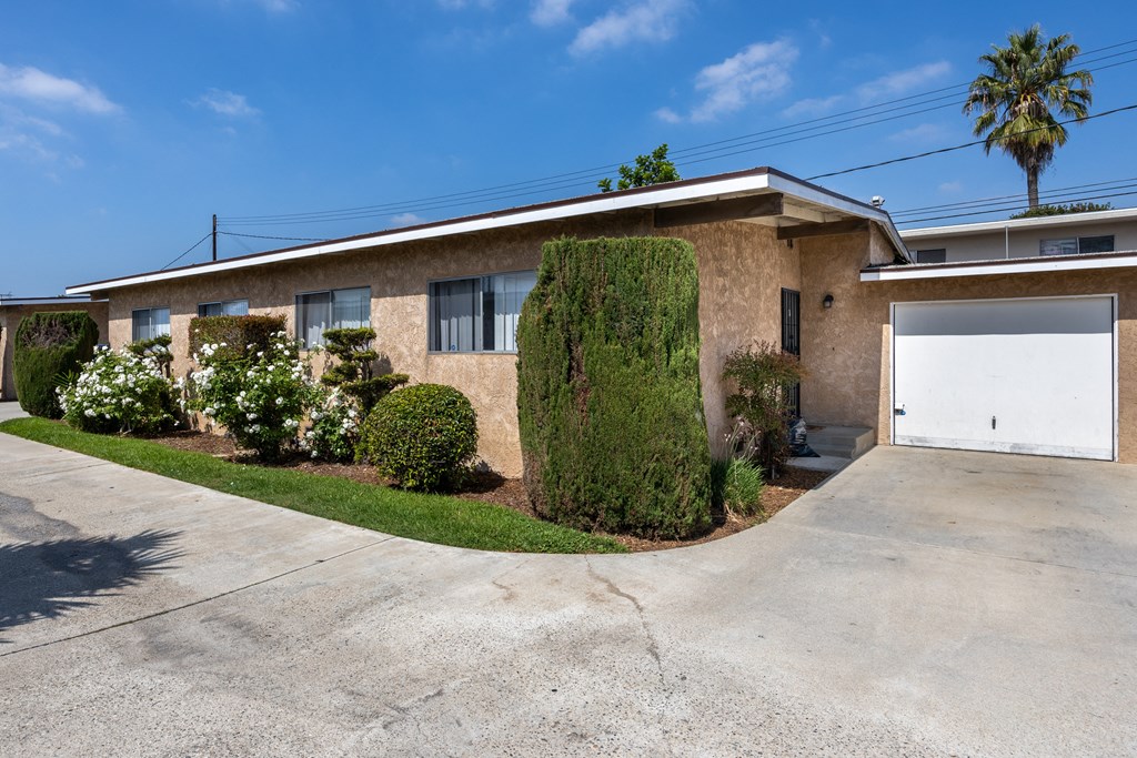 a tan brick house with a white garage door