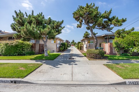 a street with houses on either side of a sidewalk