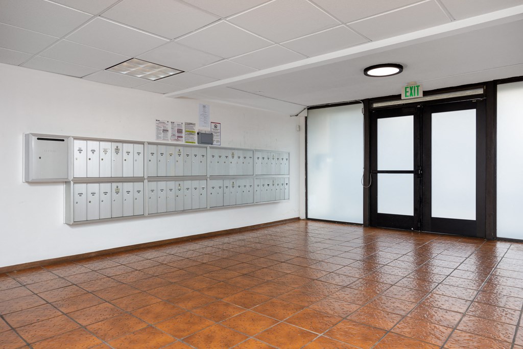 a large room with lockers on the wall and a door