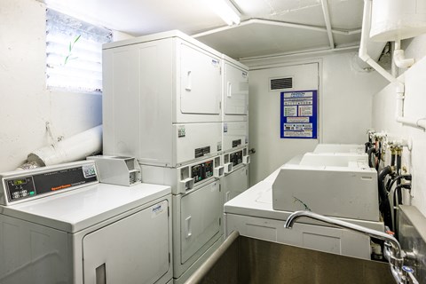 a small kitchen with white appliances and a sink