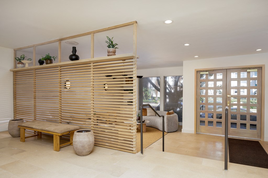 a living room with a wooden wall and a door