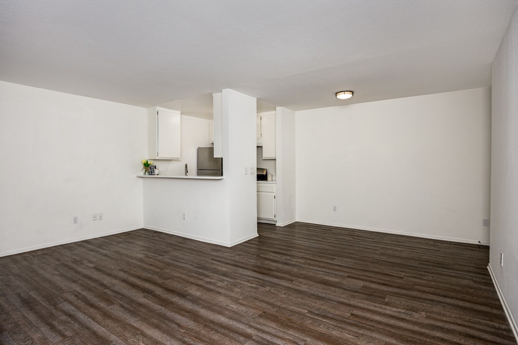 A room with wooden floors and white walls.