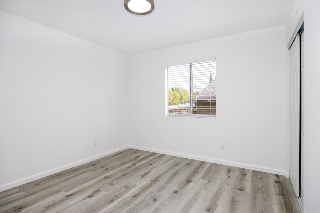 an empty room with white walls and a window