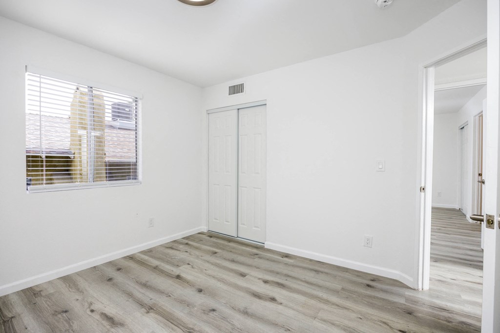 an empty room with white walls and a window