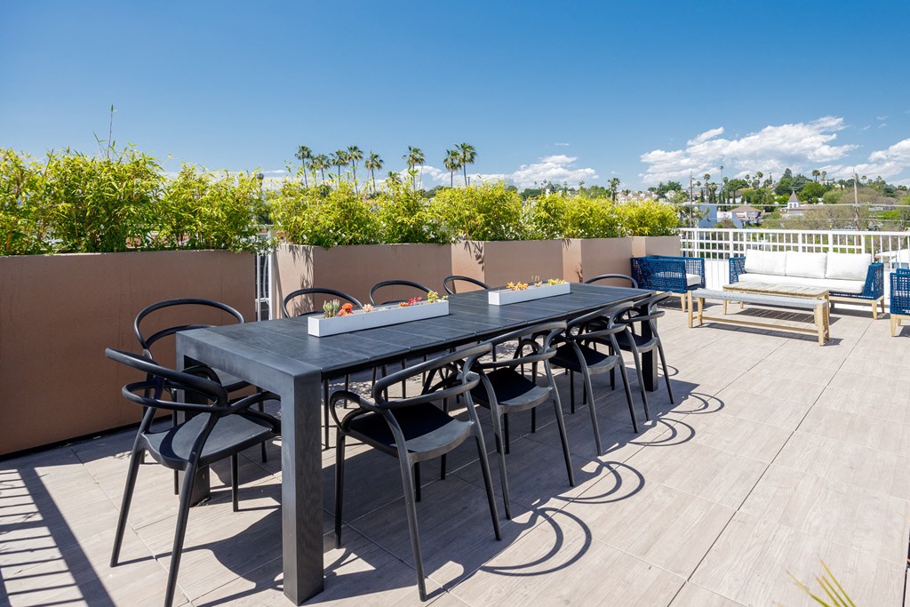 the outdoor dining table on the roof of the home has a view of the city