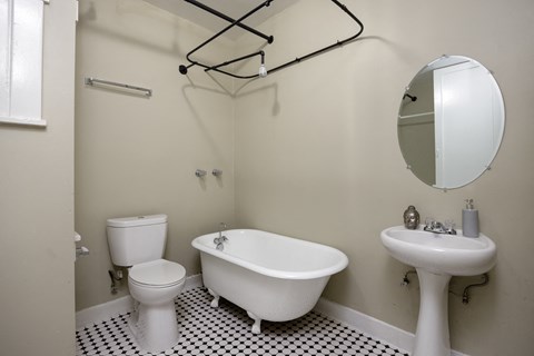 a white bathroom with a sink toilet and bath tub