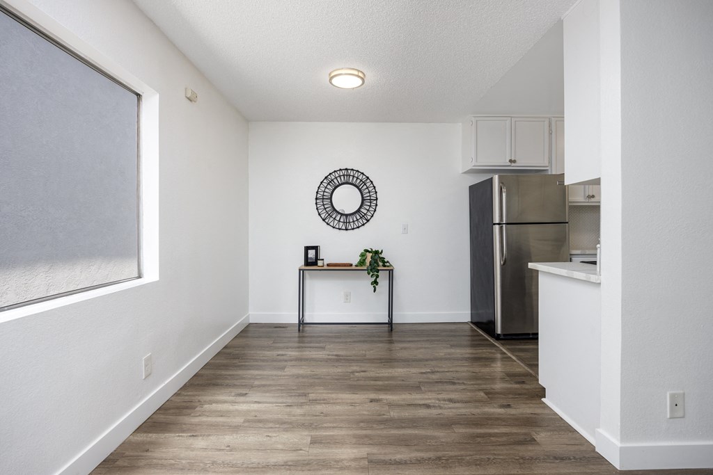 the living room and kitchen of a modern apartment with stainless steel appliances