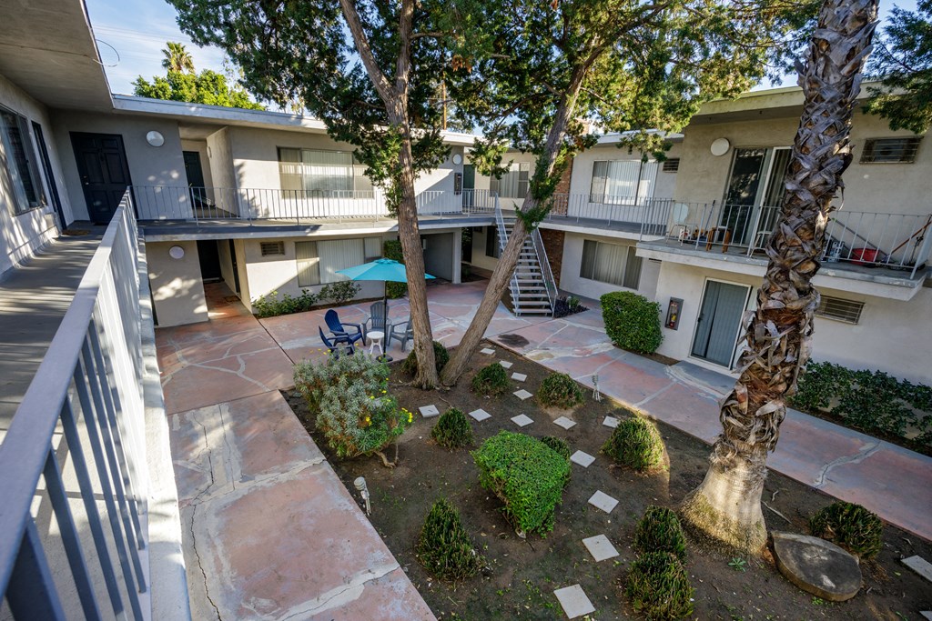 a view of the courtyard of a building with trees