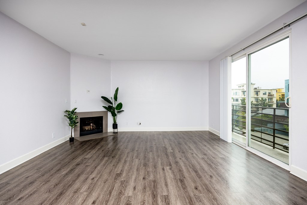 an empty living room with white walls and a fireplace
