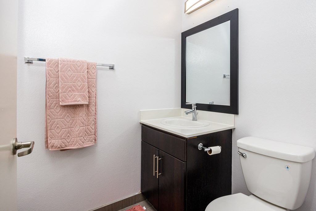 a small bathroom with a toilet sink and mirror