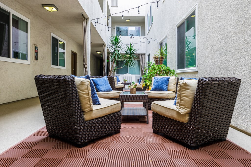 a patio with wicker furniture and a coffee table