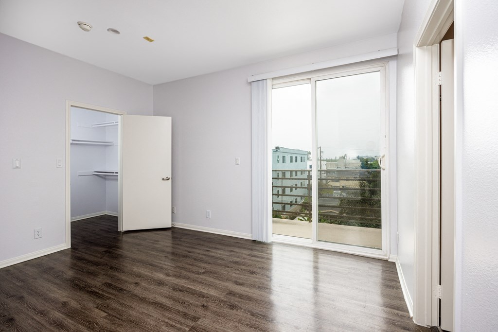 a living room with a large window and a door to a closet