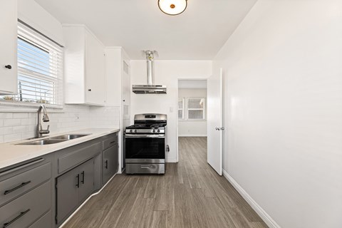 A kitchen with a stove and a sink.