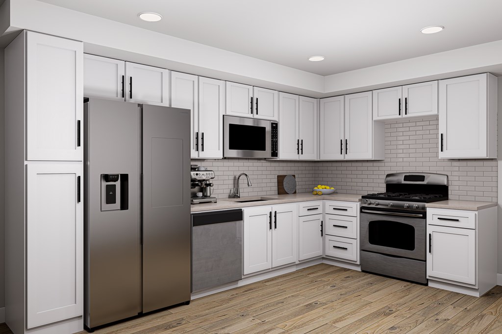 A modern kitchen with a stainless steel refrigerator and white cabinets.