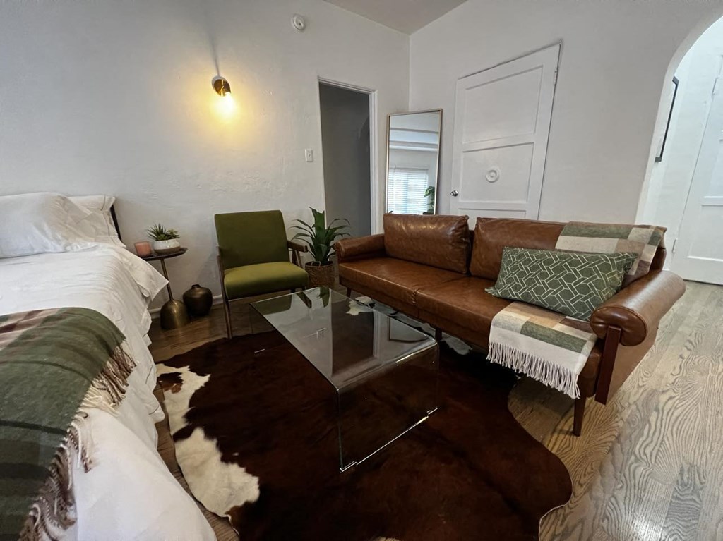 a living room with a couch and a glass table