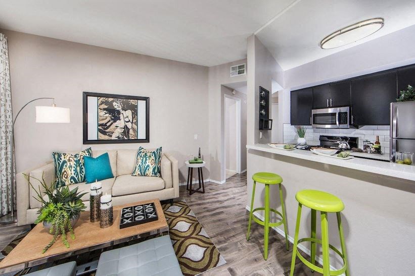 a living room with a couch and two stools