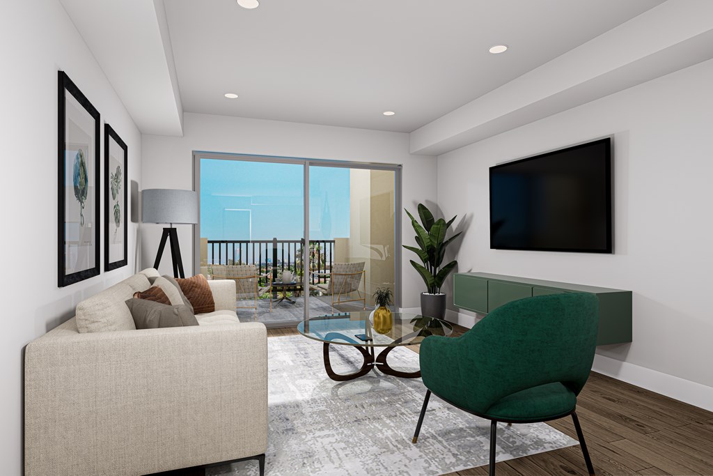 A living room with a green chair and a white couch.
