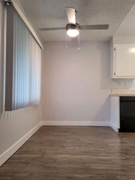 an empty room with a ceiling fan and a window