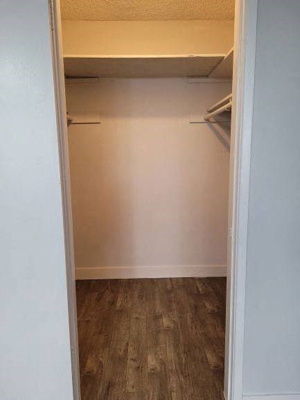 an empty closet in a room with a wooden floor