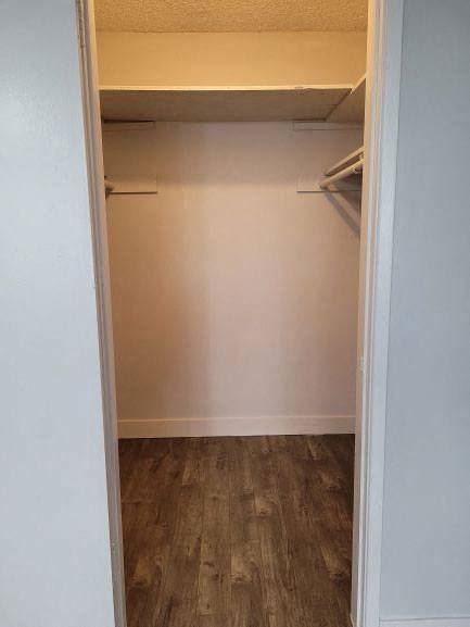 an empty closet in a room with a wooden floor