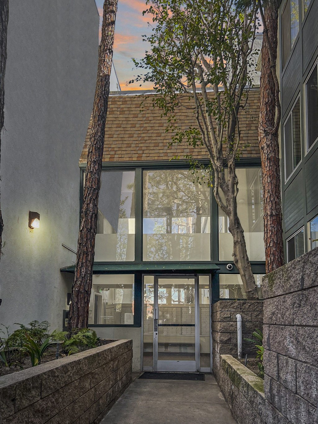a view of the front entrance of a building with trees