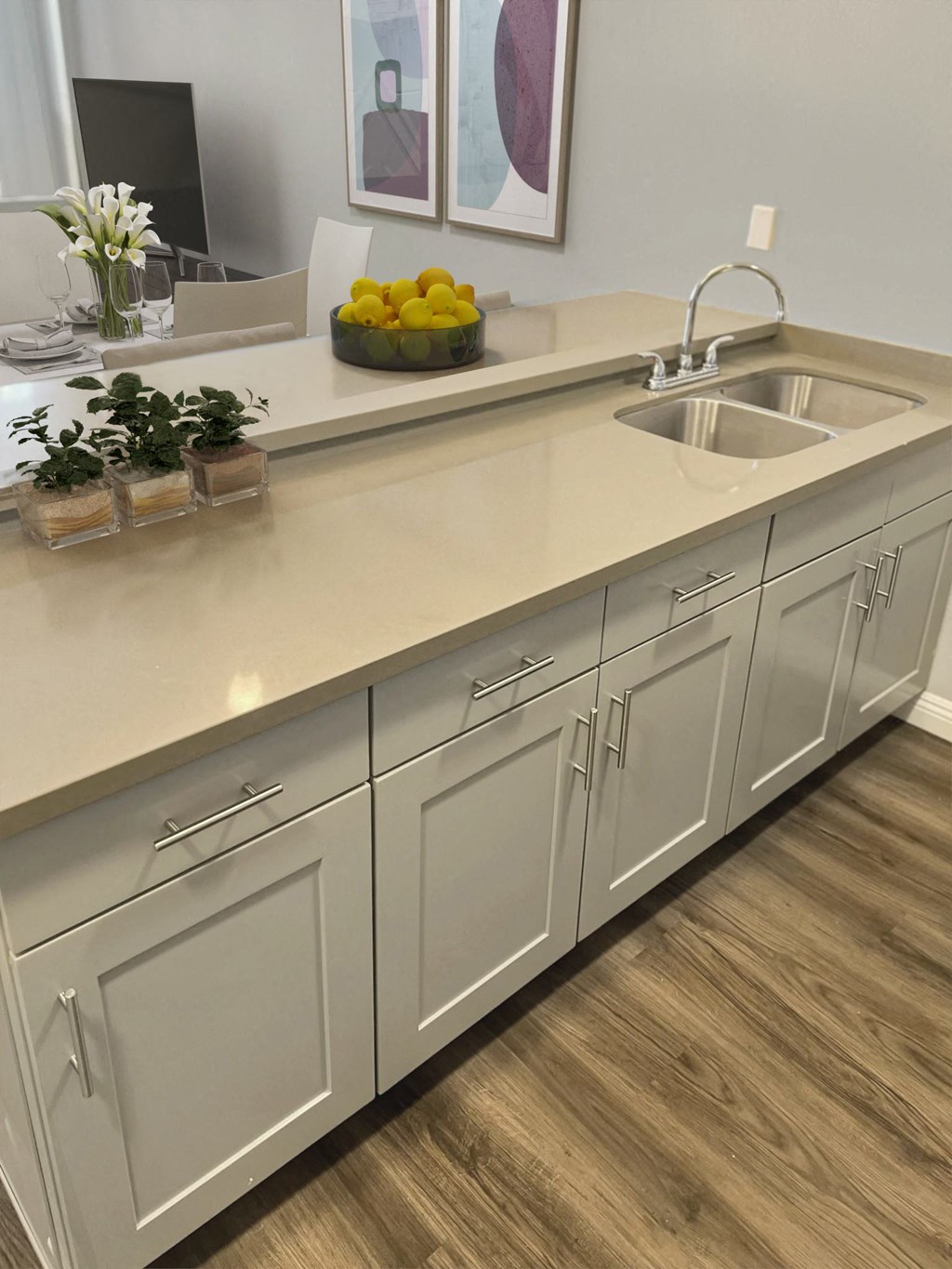 a kitchen with white cabinets and a sink